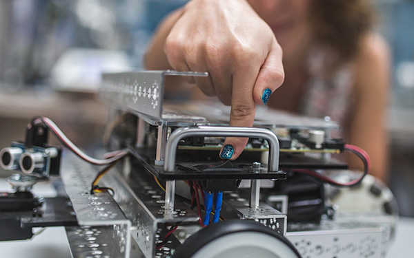 Image-Finger pressing the power button on a robotic in product development