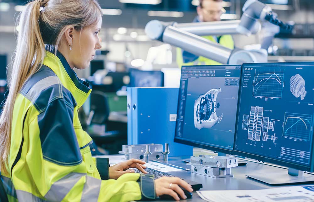 Image-Engineer looking at 3D drawings on the factory floor.