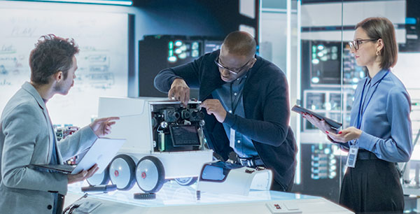 Image-Engineers Working on Remotely Controlled Mobility Robot in a Research Facility.