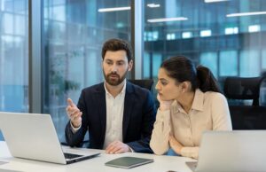 Image-Two employees looking at laptop concerned