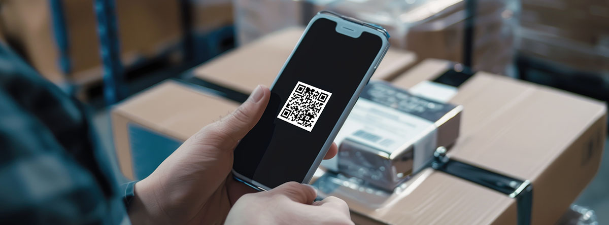 Image-Person scanning electronics box QR code on smartphone in a big box store