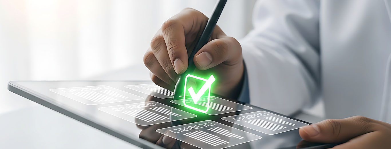 Image-Scientist or medical engineer viewing digital documents on a tablet with a glowing green checkmark