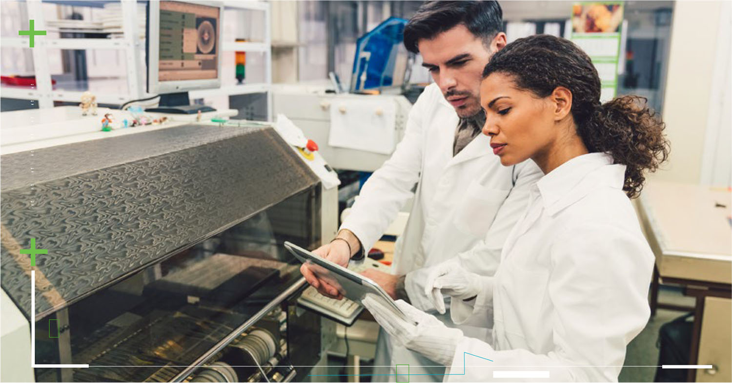 Post-Market Surveillance (PMS) - Scientists/Engineers viewing a tablet next to complex machines