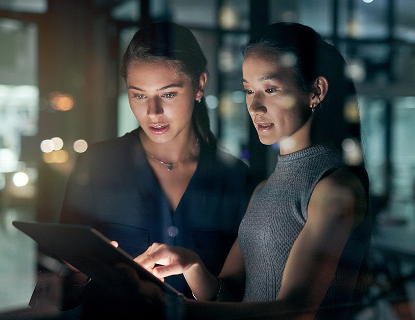 Coworkers collaborating on tablet in industrial setting