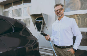 Man using electric vehicle charger