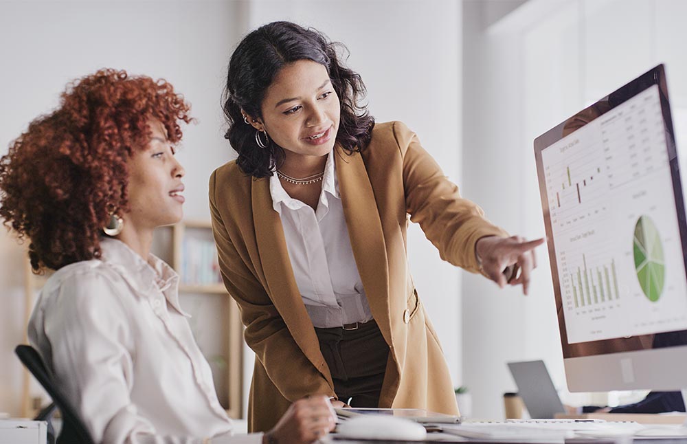 Employees Looking at Analytics Dashboard on Computer Screen