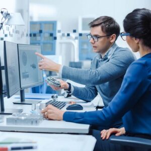 Image-Engineer and Project Supervisor Comparing a Machine Part to a 3D rendering on Computer Screen