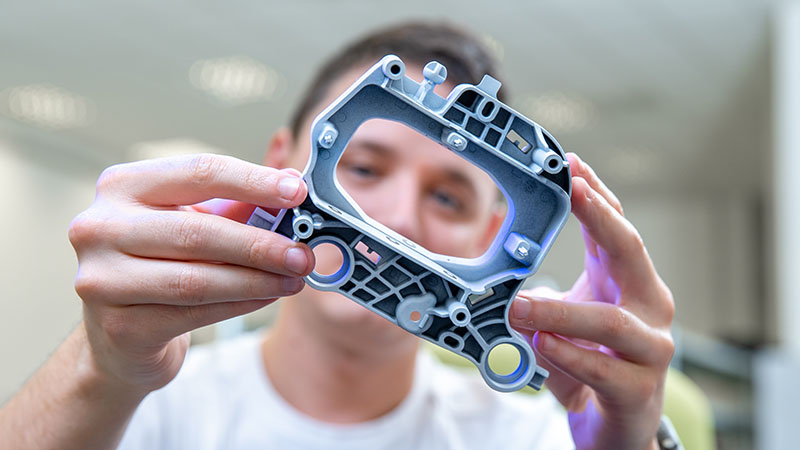 Image-engineer examines a new component in a research laboratory