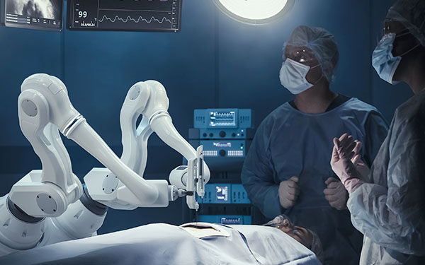 Image-Two Surgeons Observing Precision Automated Robot Arms Operating on Patient