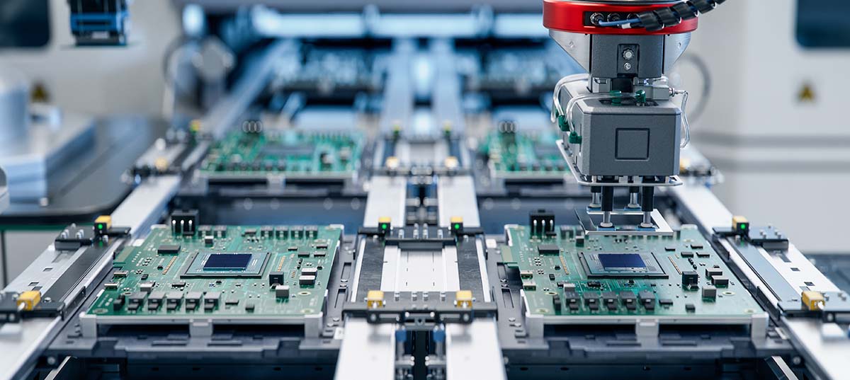 Image-Closeup of automated assembly line making electronic devices