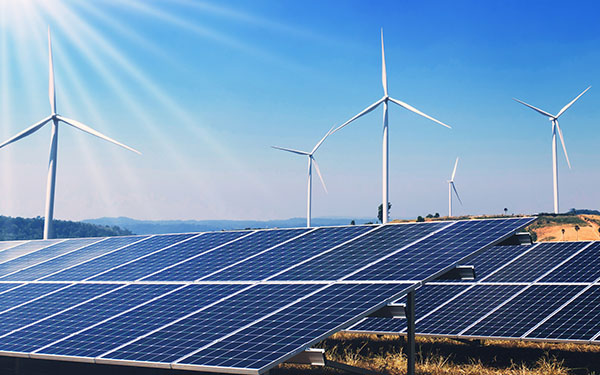 Image-clean energy power; solar panels and wind turbine on hill