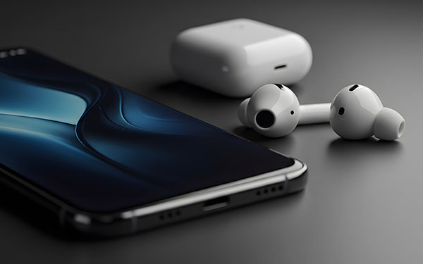 Image-Sleek smartphone and wireless earbuds rest on a dark surface