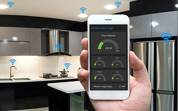 Image-Hand holding a smart with home application displaying kitchen appliances dashboard