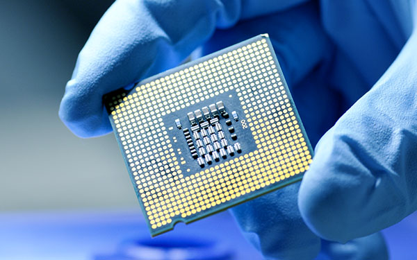Image-Close-up of a Gloved Hand Holding a New Generation Microchip.