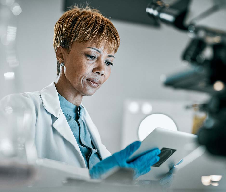Image-Engineer/scientist using a tablet in medical device development environment.