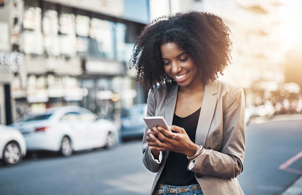 Image-Woman looking at PLM on phone