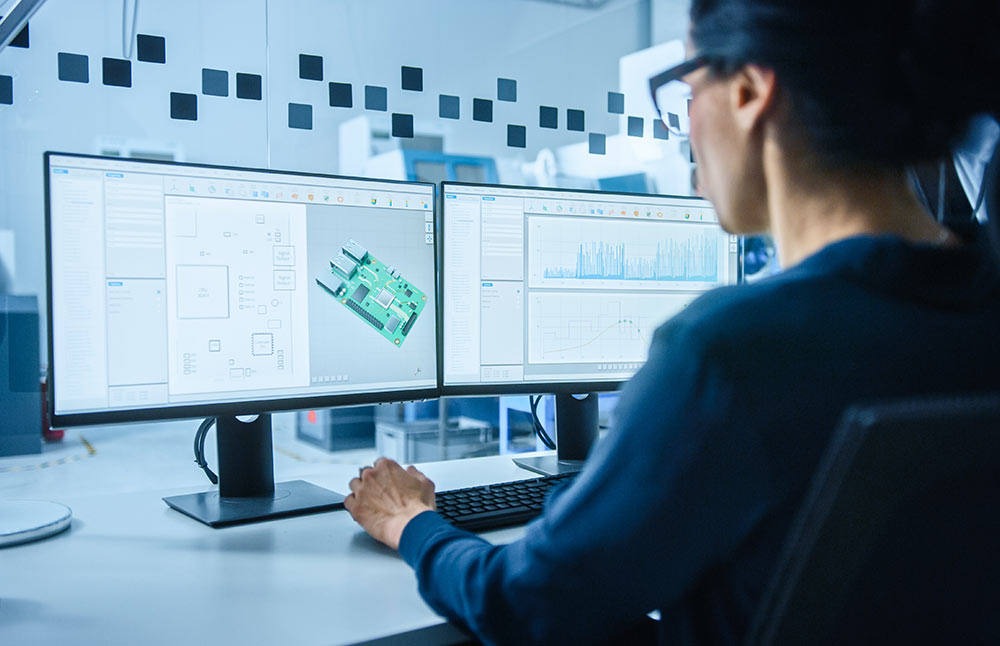 Female engineer using PLM, ERP, and CAD