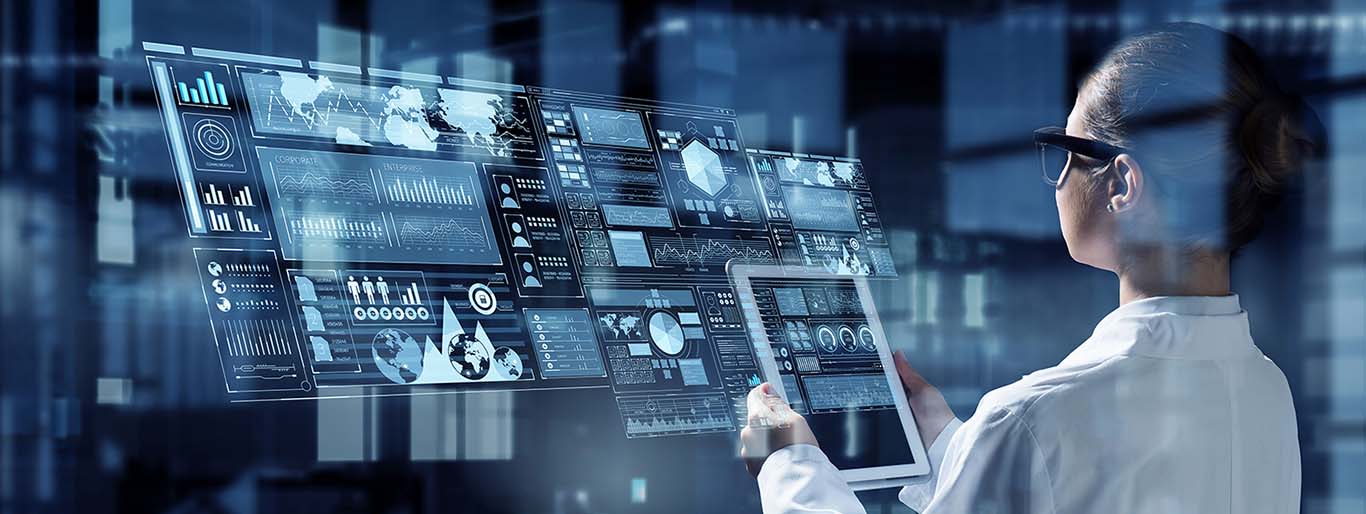 Is Product-Centric Qms Right for Your Company? Image-Medical engineer using tablet in front of mutiple displays.