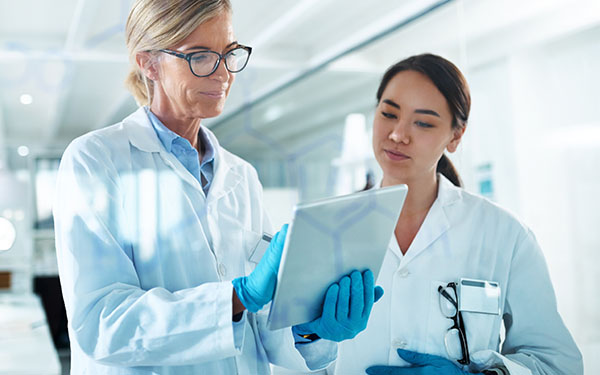 Image-Scientists in discussion with tablet, reading and reviewing