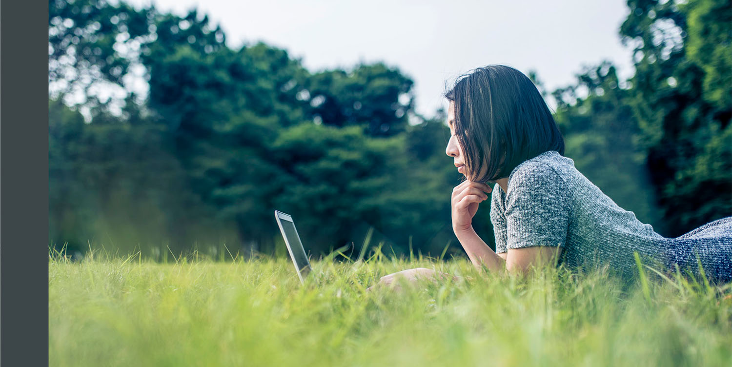 Photo of you professional using a laptop in a field