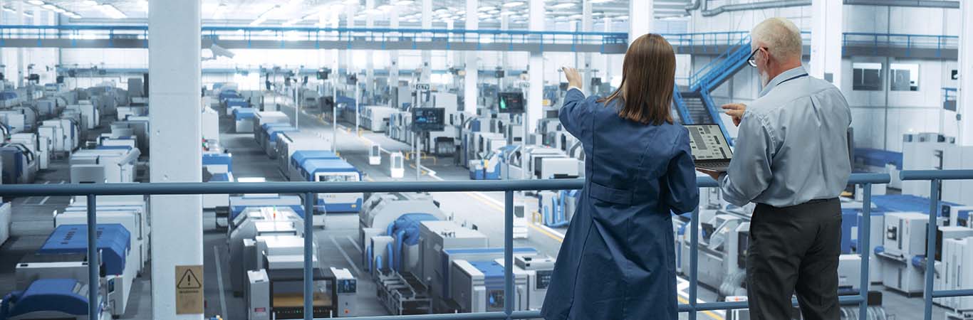 Image-Engineers Using Laptop Computer and Talking in a Factory Facility with Equipment Producing Modern Electronic Components