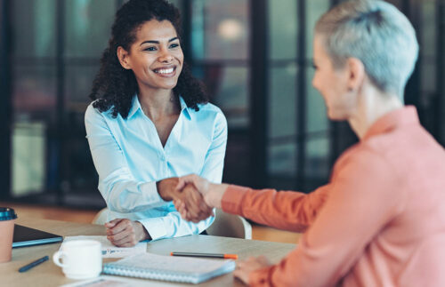 Two women shaking hands