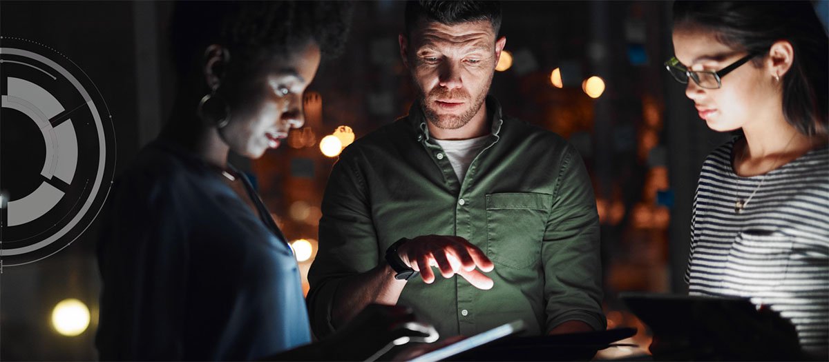 Diverse team of people discussing content on handheld device.